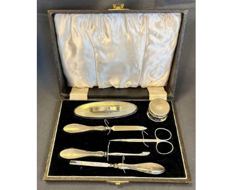 ART DECO SILVER MOUNTED MANICURE SET complete with nail buffer, cosmetic pot and files etc, decorated with engine turned engr