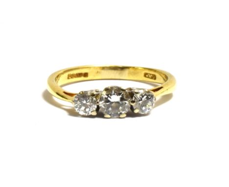 18CT GOLD THREE STONE DIAMOND RING featuring white gold, claw set round brilliant cut diamonds, estimated in the setting to t