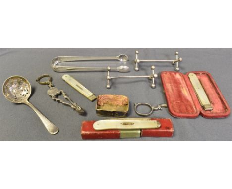 ANTIQUE STERLING SILVER ITEMS To include; a Georgian sugar sifter, sponsors mark L.L with crest to terminal, a pair of knife 