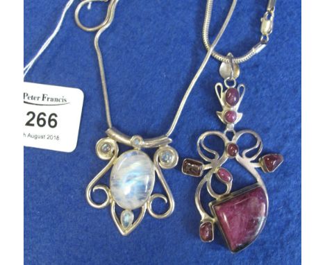 Ruby and red glass silver pendant and a moonstone silver pendant.(B.P. 24% incl. VAT)