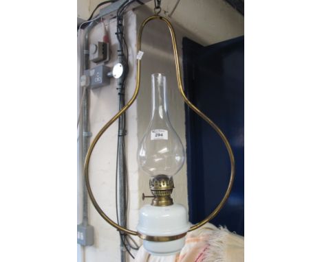 Brass single burner hanging oil lamp with ceramic reservoir and clear chimney.(B.P. 24% incl. VAT)   CONDITION REPORT:  No ob
