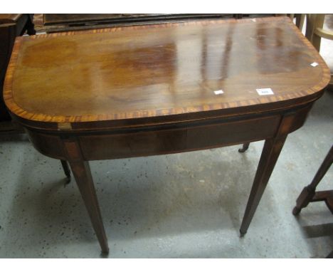 Georgian mahogany cross banded fold over card table on square legs with brass casters.(B.P. 24% incl. VAT)