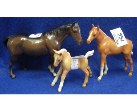 Three Beswick china horses, bay standing mare and two palomino foals, printed marks. (3)(B.P. 24% incl. VAT)