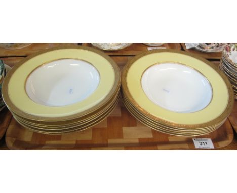 Set of eleven Royal Worcester bone china soup dishes with gilded Classical urn yellow ground borders, printed marks.(B.P. 24%