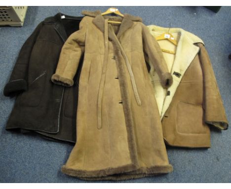 Three vintage sheepskin coats, one is a long lady's light brown sheepskin with a Baily's of Glastonbury label, size 12, with 