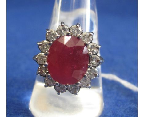 18ct white gold, ruby and diamond cluster ring, (ruby treated).(B.P. 24% incl. VAT)