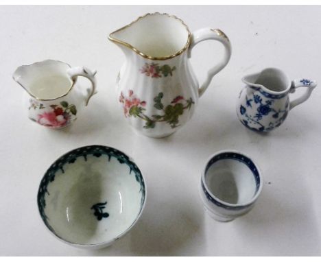 An 18th Century blue and white Worcester tea bowl; together with a floral decorated cream jug etc.