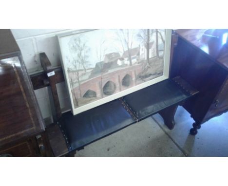 A small wooden and upholstered bench