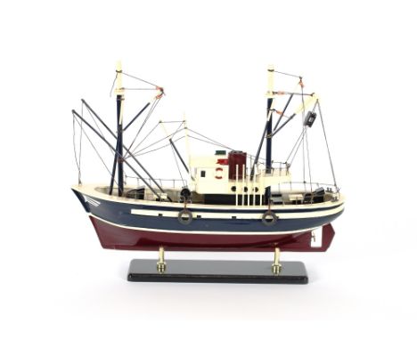 A wooden model boat; and three boxed model ships