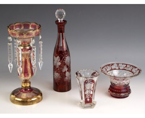 A Bohemian style ruby glass wine decanter, 20th century, the flashed glass body wheel cut with fruiting vines, with associate
