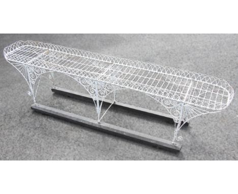 A late 19th/early 20th century painted wirework planter, of oblong form, with an openwork gallery, upon six supports united b