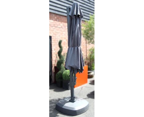 A Kettler 3.5 metre free arm parasol with LED lighting and wireless speaker, the adjustable and extending arm upon a weighted