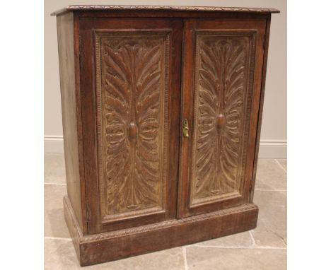 A 17th century style carved oak cupboard, 19th century, the rectangular moulded top over a pair of acanthus carved cupboard d