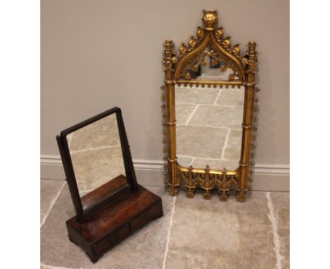 A Puginesque gilt composite wall mirror, late 20th century, of ogee form, moulded in relief with acanthus and fleur-de-lis de