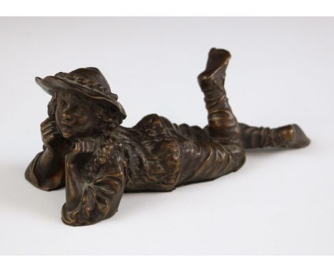 A bronze patinated figure modelled as a shepherd boy lying on his stomach, probably French, early 20th century, 15.5cm long 