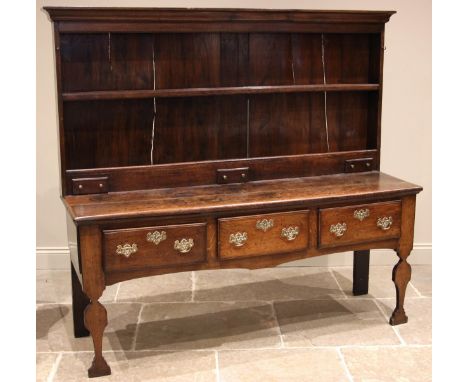 An 18th century oak dresser, the enclosed rack with a  moulded cornice over a single shelf, upon a superstructure back with t