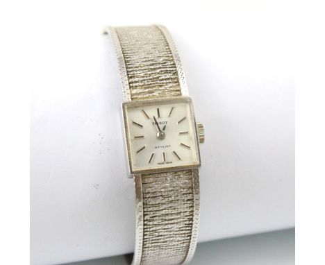 A 9ct white gold Tissot Stylist ladies wristwatch, the square faced dial with baton markers, set to plain polished case, 1.5c