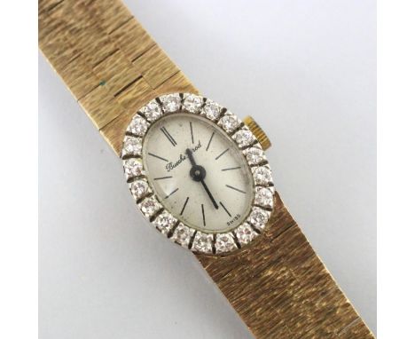 A Bueche Girod diamond set 9ct yellow gold ladies cocktail watch, the circular cream dial with baton markers, within a diamon