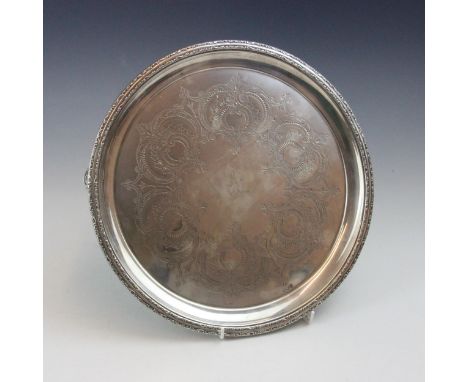 A Victorian silver salver, possibly Lee &amp; Wigfull (makers mark rubbed), London 1894, the cast scroll border above an engr