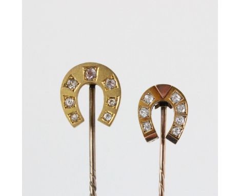 An early 20th century diamond set stick pin, the horse shoe shaped head set with seven graduated old cut diamonds, within a y