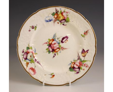 A Welsh porcelain cabinet plate, probably Nantgarw, early 19th century, the relief moulded body hand painted with floral spra