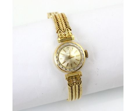 A yellow metal Tissot ladies wristwatch, the circular white dial with baton markers, set to plain polished case, 1.9cm wide, 