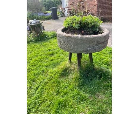 A circular sandstone trough, with associated painted iron stand, 29cm H x 90cm D 