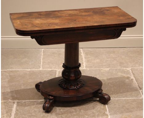 A William IV rosewood pedestal card table, the rectangular folding top opening to a circular baize lined surface, over a foli