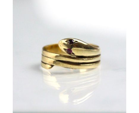 A 9ct yellow gold and untested ruby serpent ring, the coiled snake with red stone set eyes, stamped 'S&amp;K' London, indisti