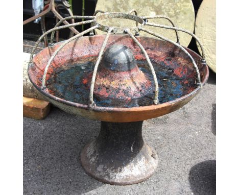 A cast iron feed trough, with ten divisions, 86cm D, upon an associated implement hub (2) 