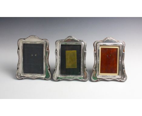 A pair of George V silver mounted photograph frames, J and R Griffin, Chester 1916, with embossed trailing floral decoration 