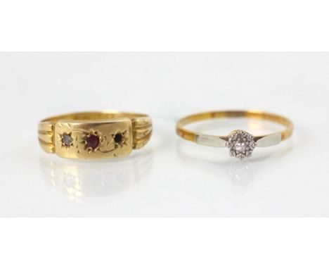 An 18ct yellow gold and untested ruby ring, the rectangular panel set with central round cut red stone with diamond to one si