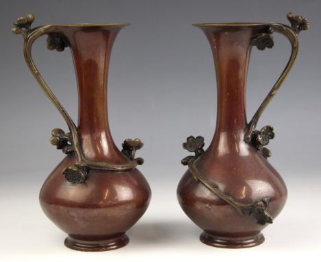 A pair of Japanese polished bronze vases, Meiji Period (1868-1912), each of trumpet form with bulbous bodies and applied cher