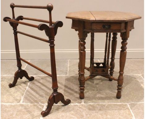 A medium oak ecclesiastical occasional table, early 20th century, the octagonal moulded top over a pair of opposing frieze dr