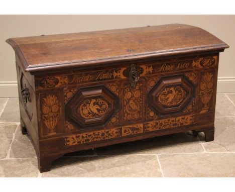 An early 19th century German oak, walnut and marquetry domed marriage chest, the hinged cover opening to a pair of fitted can