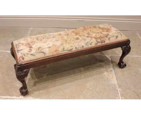 A Chippendale revival mahogany long stool, early 20th century, the drop-in tapestry seat (at fault), upon acanthus moulded sh