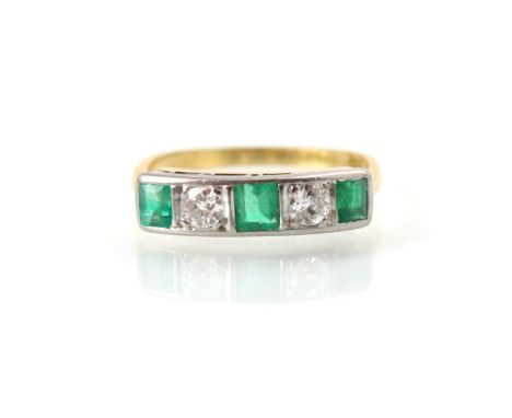 An early 20th century style untested emerald and diamond five stone ring, the two old cut diamonds with three graduated calib