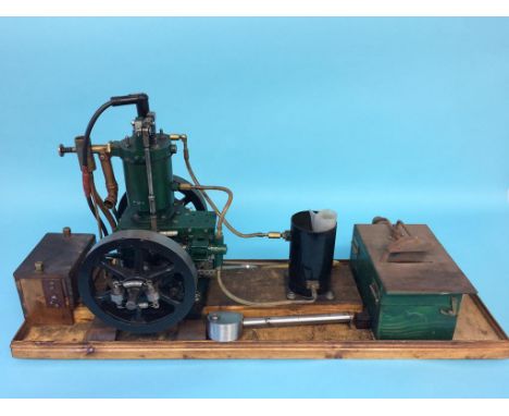 A live single cylinder petrol powered engine, with table saw, on a wooden stand.  28cm width x 77cm length (overall size)