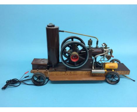 A single cylinder petrol engine model 'Shell', on a wooden base, with wheels.  63cm length x 34cm height