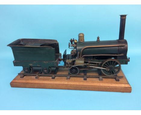 A 3 ½ inch gauge live model of an early steam locomotive, 2-2-0, with green livery