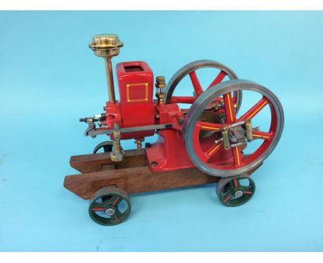 A hopper fed horizontal model engine, Amanco Waterloo Iowa, USA, on wood support with wheels.  34cm x 28cm