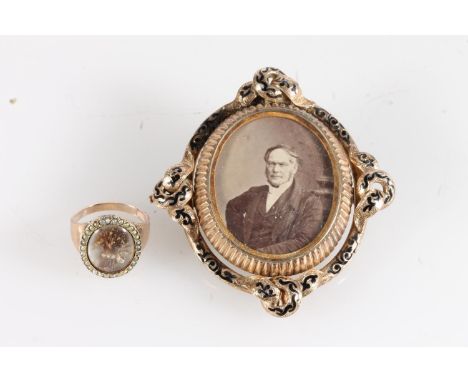 Victorian yellow metal mourning brooch, the oval portrait of a seated gentleman framed by black enamel ribbon border, the rev