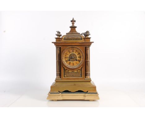 Antique French gilt metal mantle clock decorated with damascene work to the panels and the columns, the movements striking on