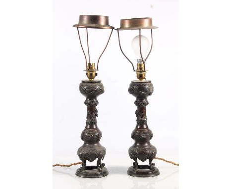 Pair of Oriental bronze table lamps of incense burner form decorated with relief flowers and foliage.