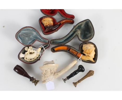 Three antique letter seals with carved intaglio seals and four meerschaum smoking pipes.