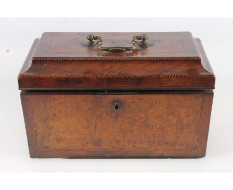 19th century walnut tea caddy of casket form with sarcophagus top opening to reveal three cannister interior, 25cm long.