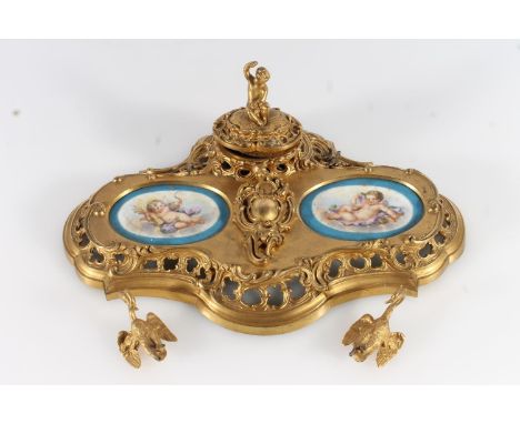 French gilt metal ormolu style deskstand in the Rococo style inset with Sèvres style porcelain panels with hand painted cheru