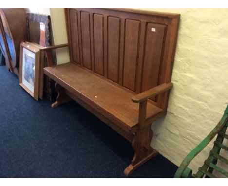 An oak panel backed settle bench.