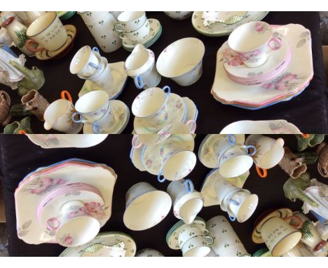 A Shelley tea service with floral decoration in blue, pink and orange.