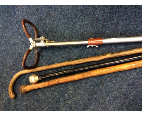 A silver topped cane together with a shooting stick, etc.